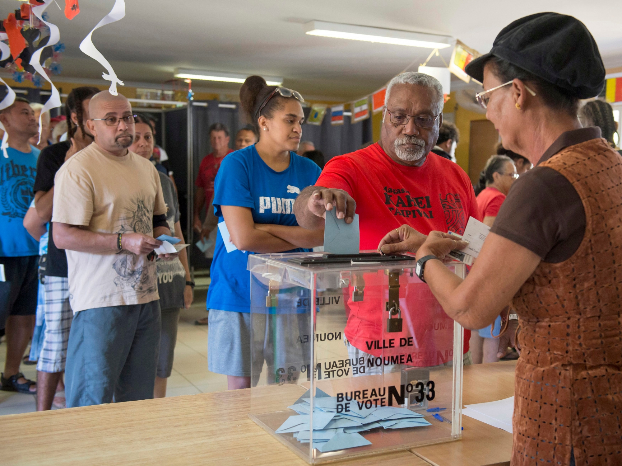 A man casts his vote at a polling station in Noumea, New Caledonia, as part of an independence referendum, Sunday, Nov. 4, 2018. Voters in New Caledonia are deciding whether the French territory in the South Pacific should break free from the European country that claimed it in the mid-19th century. (AP Photo/Mathurin Derel) New Caledonia Referendum