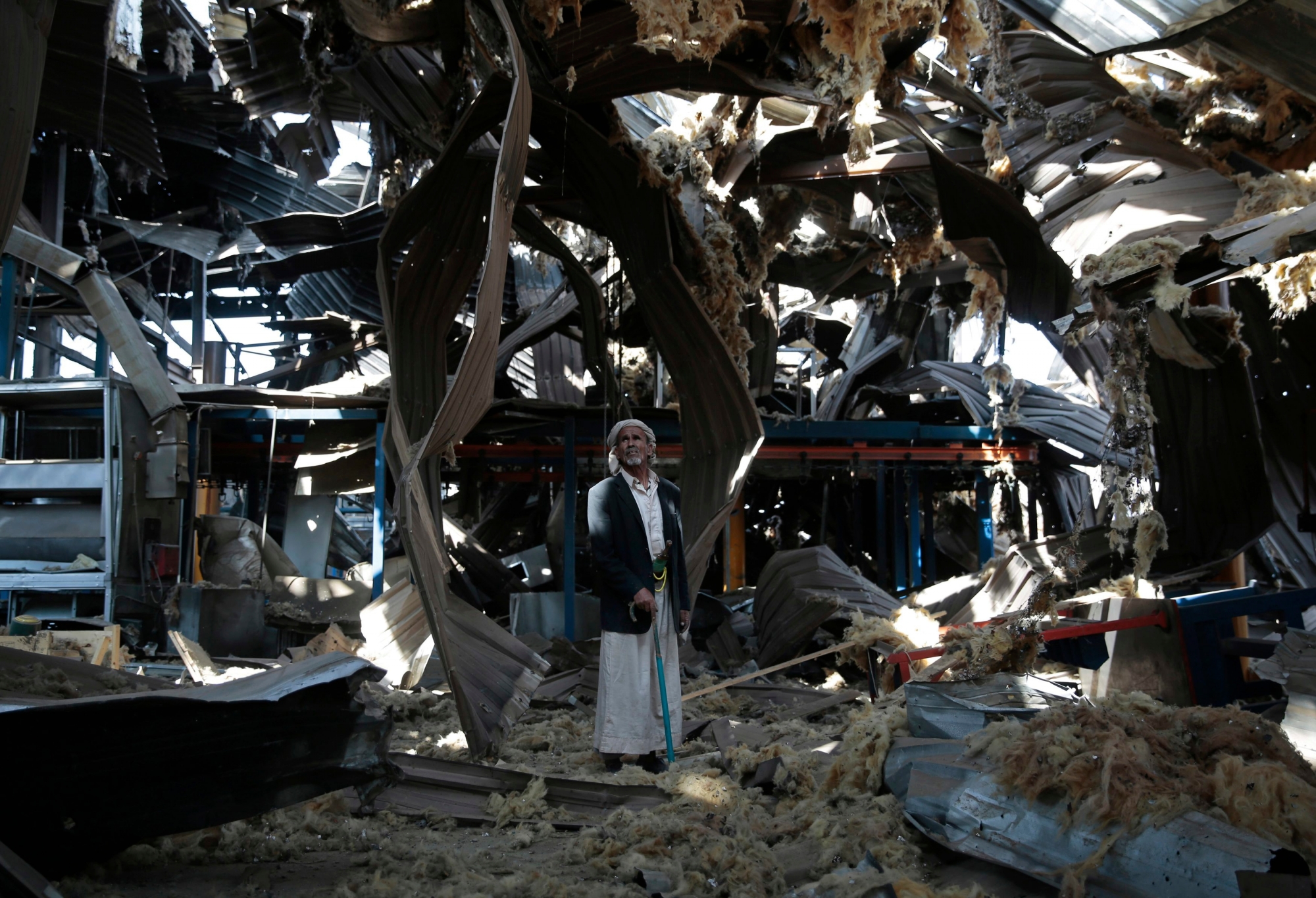 FILE - In this Sept. 22, 2016, file photo, a man stands among the rubble of the Alsonidar Group's water pump and pipe factory after it was hit by Saudi-led airstrikes in Sanaa, Yemen. The Saudi-led coalition fighting in Yemen said early Saturday, Nov. 10, 2018, it had "requested cessation of inflight refueling" by the U.S. for its fighter jets after American officials said they would stop the operations amid growing anger over civilian casualties from the kingdom's airstrikes. (AP Photo/Hani Mohammed, File) Yemen