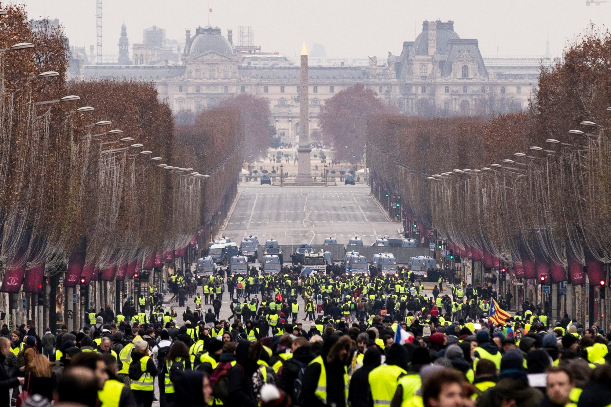 epa07233178 Protesters gather during a Yellow Vest demonstration on the Champs Elysees in Paris, France, 15 December 2018. The so-called 'gilets jaunes' (yellow vests) is a protest movement, which reportedly has no political affiliation, that continues protests across the nation over high fuel prices.  EPA/ETIENNE LAURENT FRANCE PROTEST YELLOW VESTS