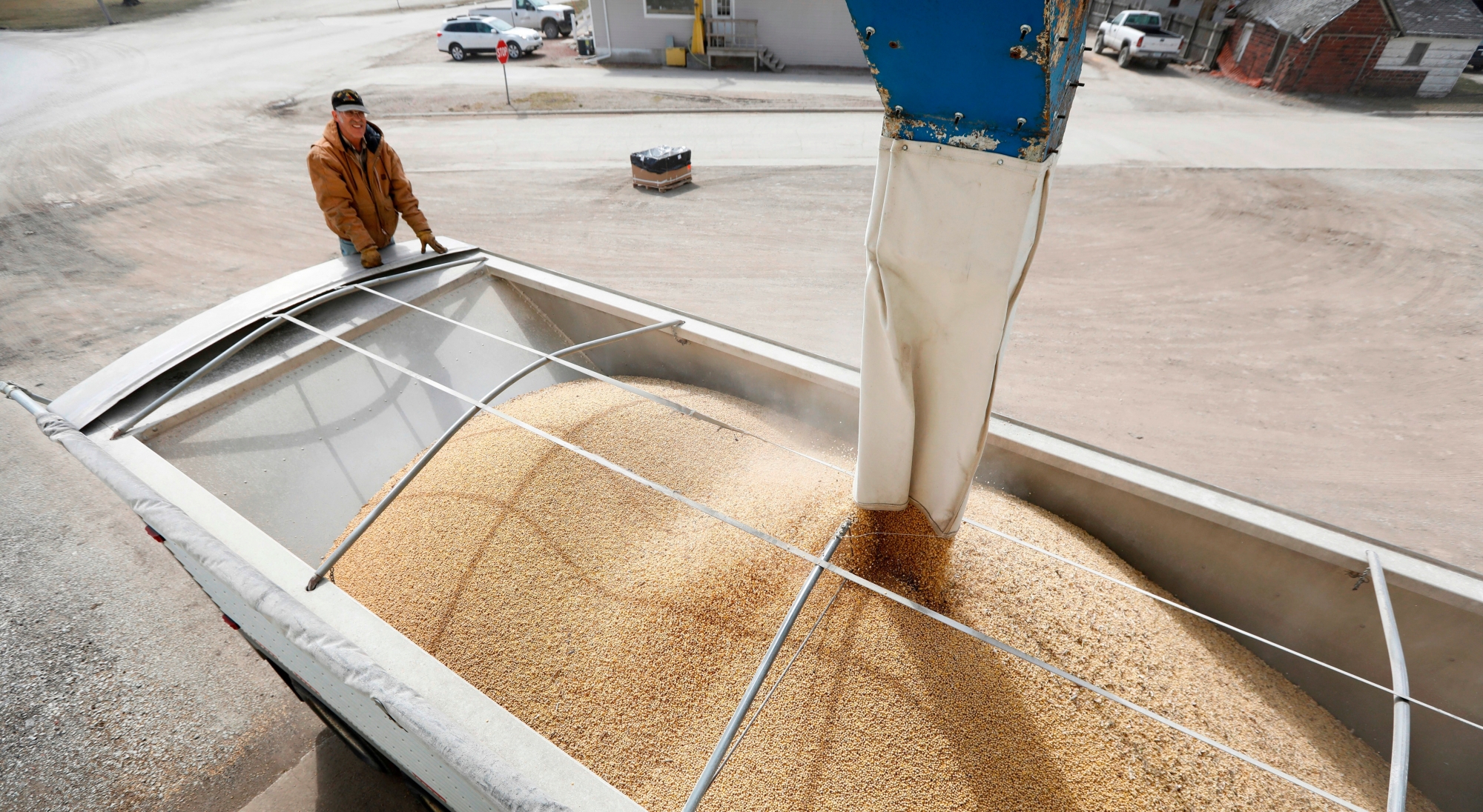 FILE - In this Thursday, April 5, 2018 file photo, Terry Morrison of Earlham, Iowa, watches as soybeans are loaded into his trailer at the Heartland Co-op,, in Redfield, Iowa. The U.S. Department of Agriculture says it must delay the release of key crop reports due to the partial government shutdown. The announcement Friday, Jan. 4, 2019, left investors and farmers without vital information during an already tumultuous time for agricultural markets. The USDA planned to release the reports Jan. 11 but said that even if the shutdown ended immediately, the agency wouldn't have time to release the reports as scheduled. (AP Photo/Charlie Neibergall, File) Government Shutdown Agriculture