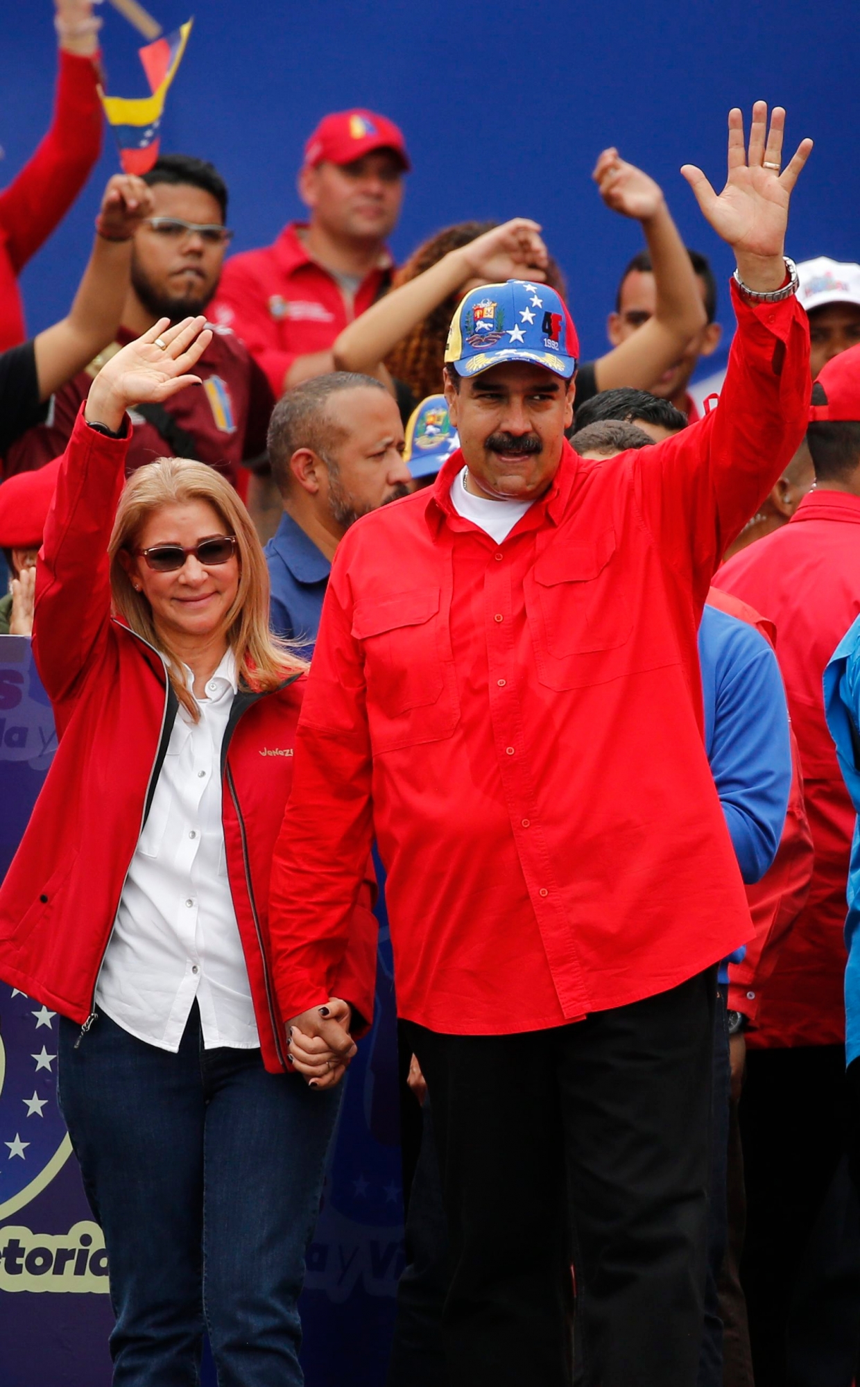 Venezuela's President Nicolas Maduro and first lady Cilia Flores acknowledge supporters at the end of a rally in Caracas, Venezuela, Saturday, Feb. 2, 2019. Maduro called the rally to celebrate the 20th anniversary of the late President Hugo Chavez's rise to power. (AP Photo/Ariana Cubillos) Venezuela Political Crisis