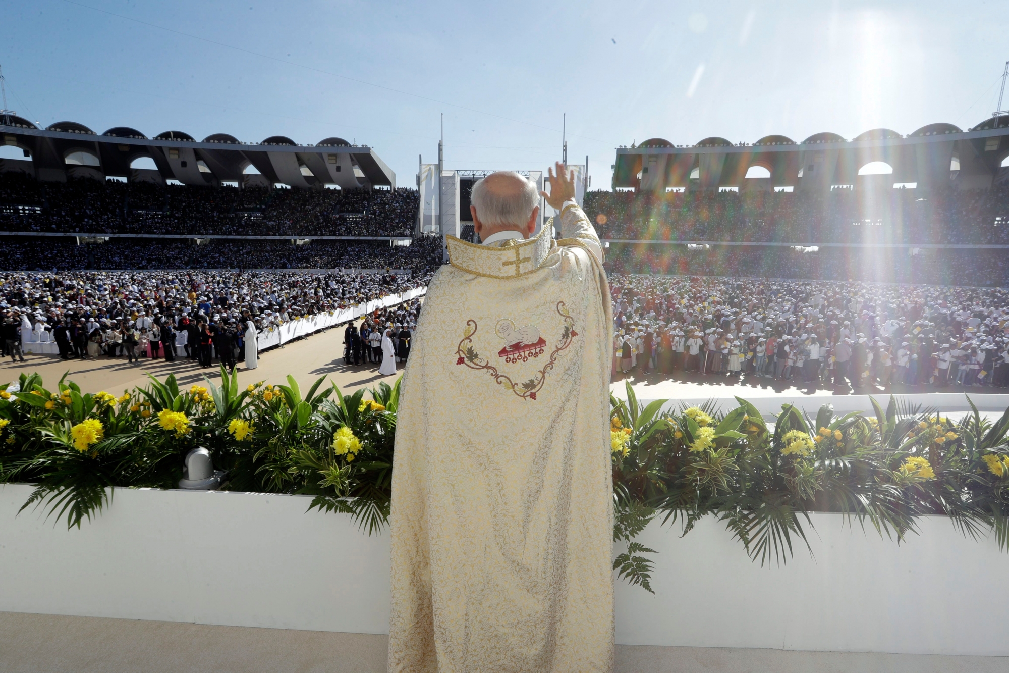 A priest waves to the crowd as he waits for the arrival of Pope Francis at the Sheikh Zayed Sports City Stadium in Abu Dhabi, United Arab Emirates, Tuesday, Feb. 5, 2019. The pontiff ministered on Tuesday to the thriving Catholic community in the United Arab Emirates as he concluded his historic visit to the Arabian Peninsula with the first-ever papal Mass here. (AP Photo/Andrew Medichini) Emirates Pope