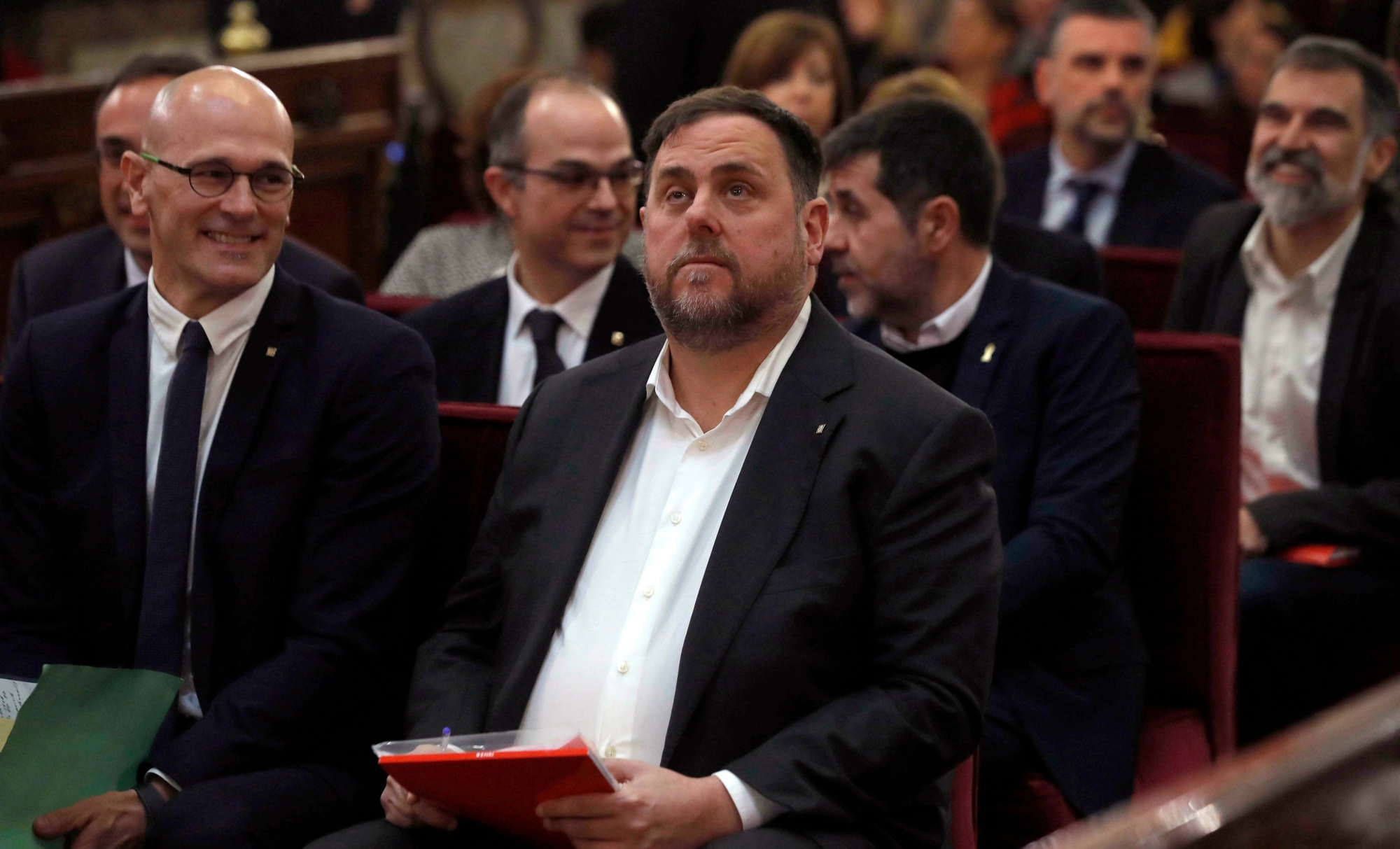 Catalan regional Vice-President, Oriol Junqueras, center, next to Catalan former Cabinet member Raul Romeva, left, during the trial at the Spanish Supreme Court in Madrid, Tuesday, Feb. 12, 2019. Spain is bracing for the nation's most sensitive trial in four decades of democracy this week, with a dozen Catalan separatists facing charges including rebellion over a failed secession bid in 2017. (J.J. Guillen/Pool via AP) Spain Catalonia Trial