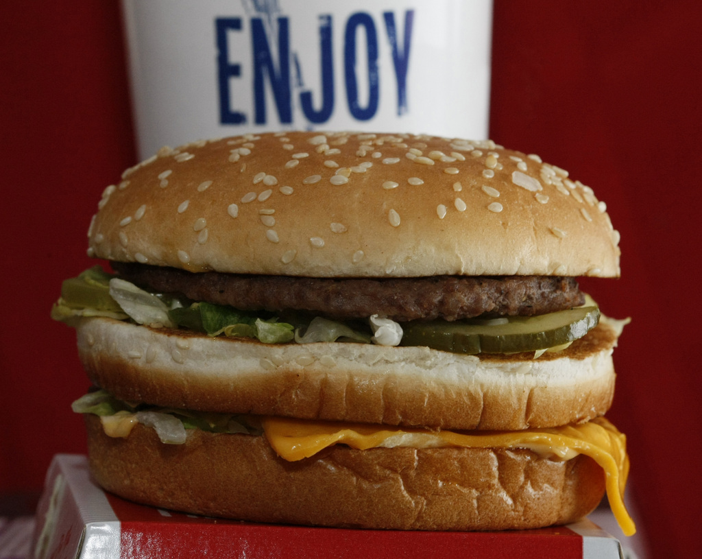 In this photo made on Dec. 29, 2009, a Big Mac sandwich is displayed in front of a drink at McDonald's in North Huntingdon, Pa. McDonald's Corp. said Friday Jan. 22, 2010, its sales and profit grew in the fourth quarter as more hungry diners gobbled up its cheap eats.(AP Photo/Keith Srakocic)