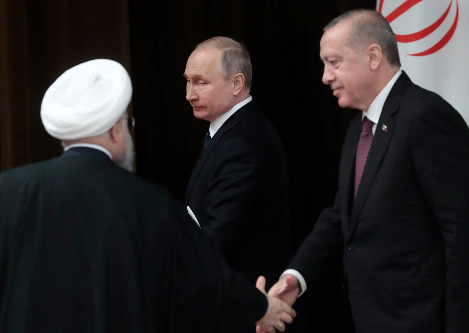 Russian President Vladimir Putin, center, Iranian President Hassan Rouhani, left, and Turkish President Recep Tayyip Erdogan leave a news conference after the talks in the Bocharov Ruchei residence in the Black Sea resort of Sochi, Russia, Thursday, Feb. 14, 2019. Putin is hosting the leaders of Turkey and Iran for talks about a Syria peace settlement as expectations mount for an imminent and final defeat of the Islamic State group. (Sergei Chirikov/Pool Photo via AP) Russia Syria