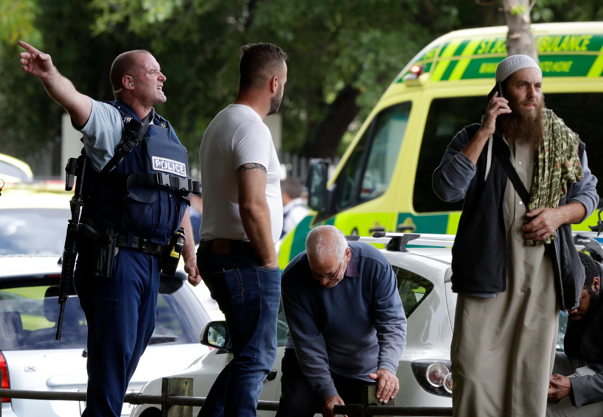 Police attempt to clear people from outside a mosque in central Christchurch, New Zealand, Friday, March 15, 2019. Many people were killed in a mass shooting at a mosque in the New Zealand city of Christchurch on Friday, a witness said. Police have not yet described the scale of the shooting but urged people in central Christchurch to stay indoors.(AP Photo/Mark Baker) New Zealand Mosque Shooting