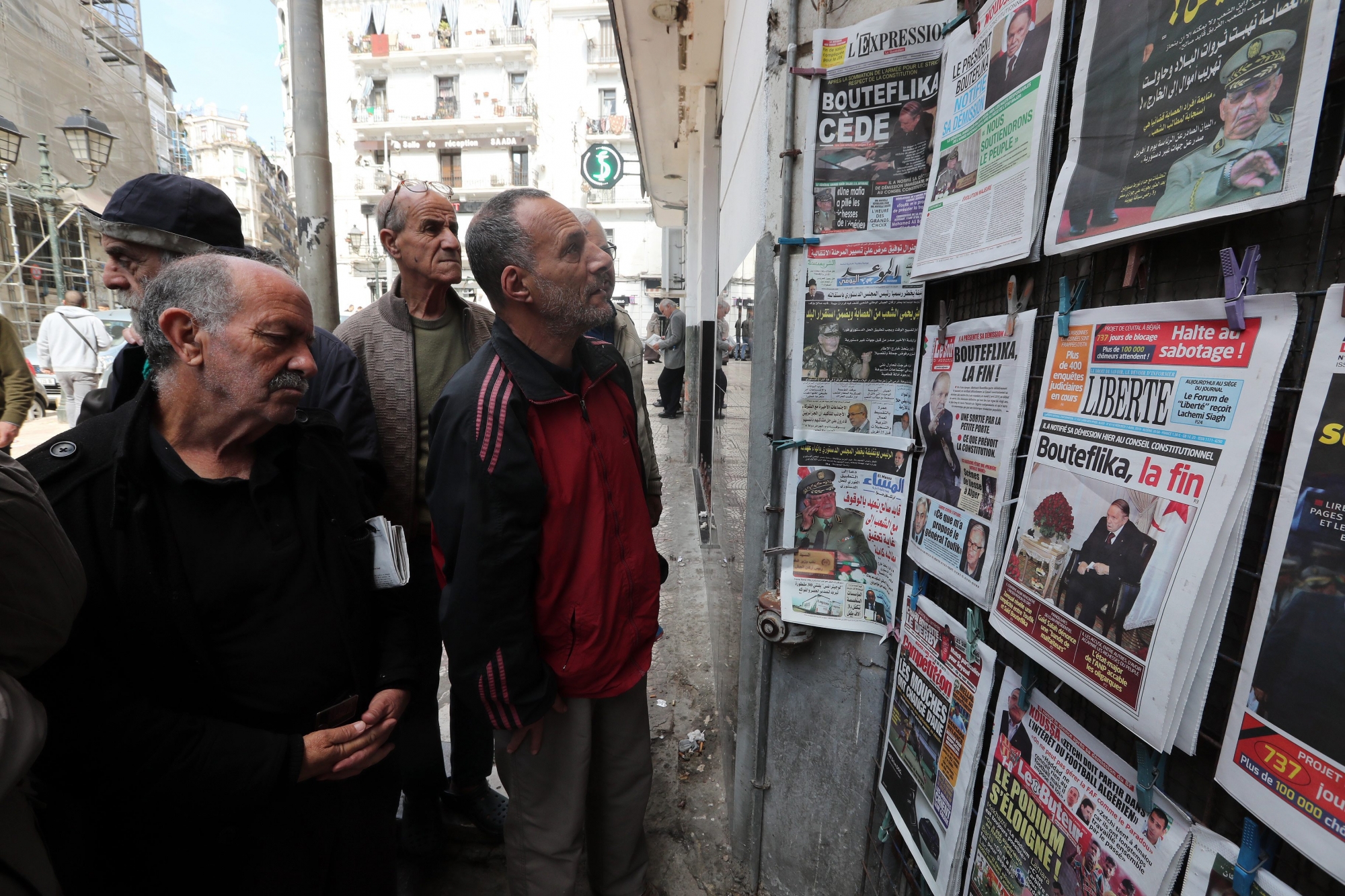 epa07482356 Algerian men look at local newspapers a day after Algeria's President Abdelaziz Bouteflika submitted his resignation, in Algiers, Algeria, 03 April 2019. According to official media reports late 02 April 2019, Bouteflika has announced his resignation, after weeks of popular mobilization against his rule and his intention to run for a fifth term in the upcoming presidential elections. Mr. Bouteflika withdrew from running for a new term but canceled Algeria's presidential election, which had been set for April 18.  EPA/MOHAMED MESSARA ALGERIA POLITICAL CRISIS