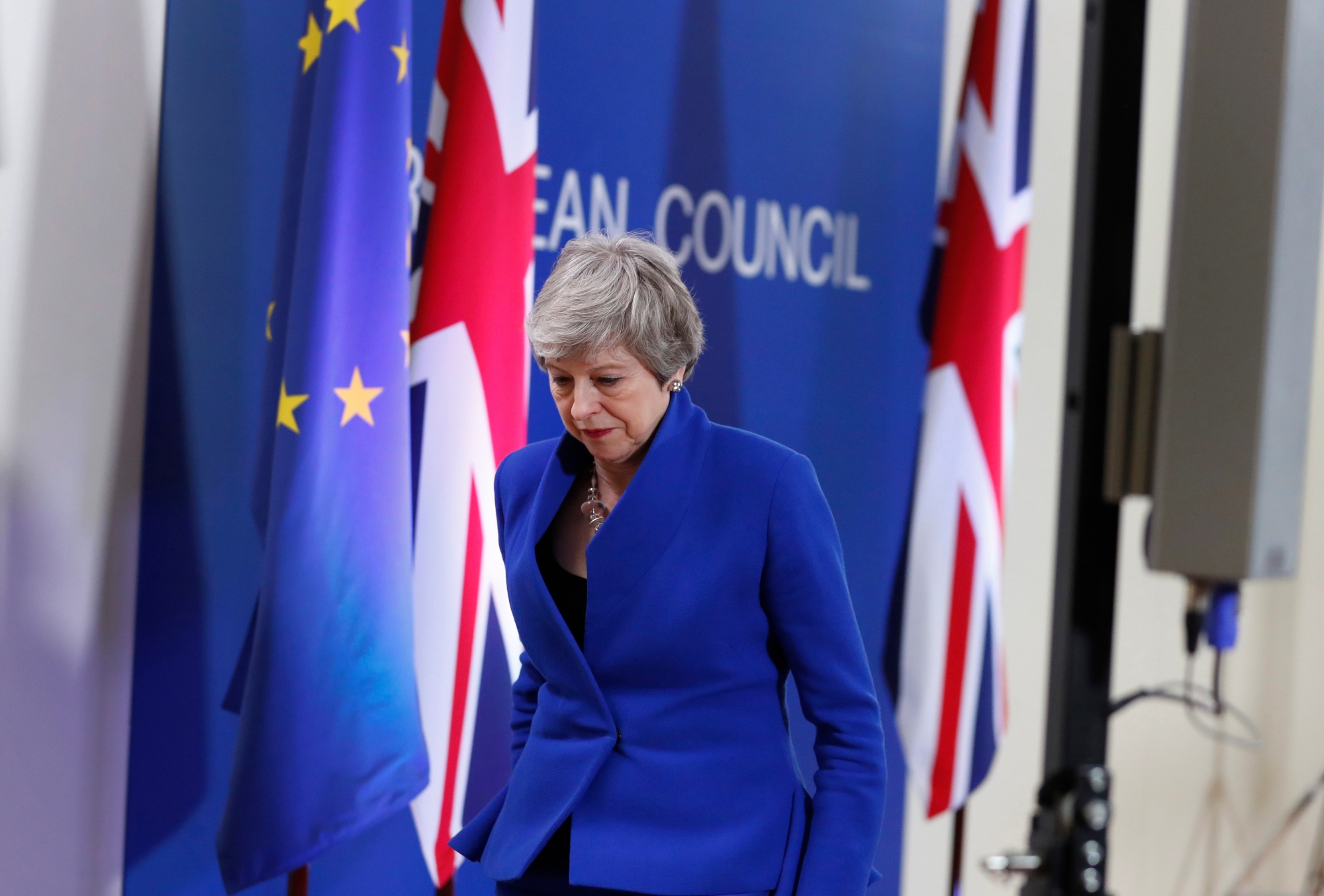 British Prime Minister Theresa May leaves the podium after addressing a media conference at the conclusion of an EU summit in Brussels, Thursday, April 11, 2019. European Union leaders on Thursday offered Britain an extension to Brexit that would allow the country to delay its EU departure date until Oct. 31. (AP Photo/Alastair Grant) Belgium EU Brexit