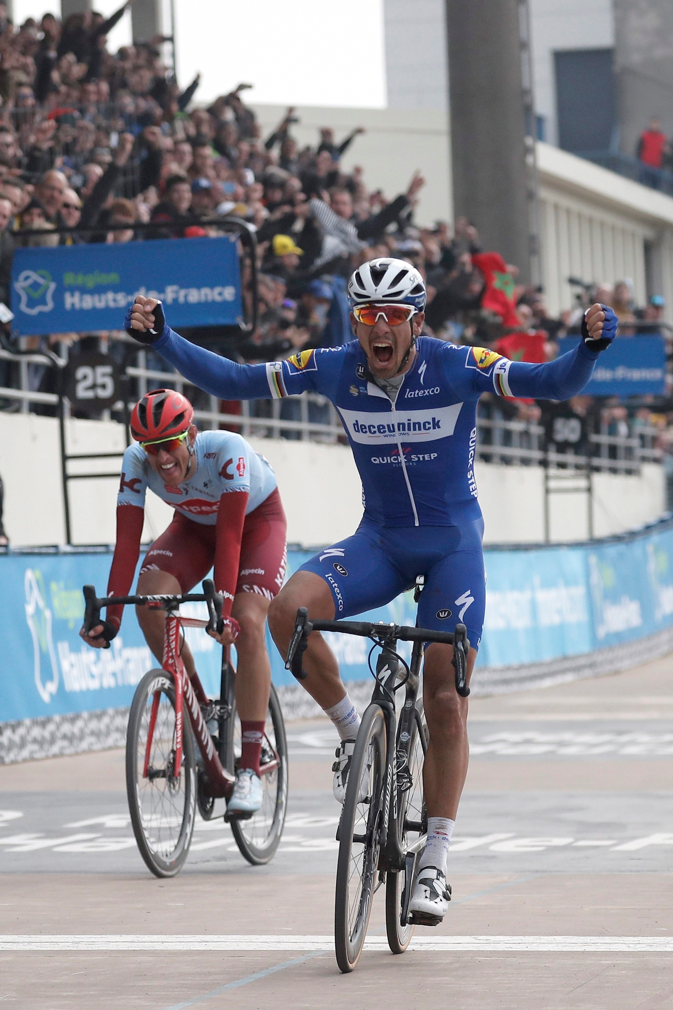epa07506516 Deceuninck Quick Step team rider Philippe Gilbert (R) of Belgium celebrates his win as he crosses the finish line of the 117th Paris Roubaix cycling race, France, 14 April 2019. Team Katusha Alpecin Nils Politt (L) finishes with second position.  EPA/CHRISTOPHE PETIT TESSON FRANCE CYCLING PARIS ROUBAIX 2019