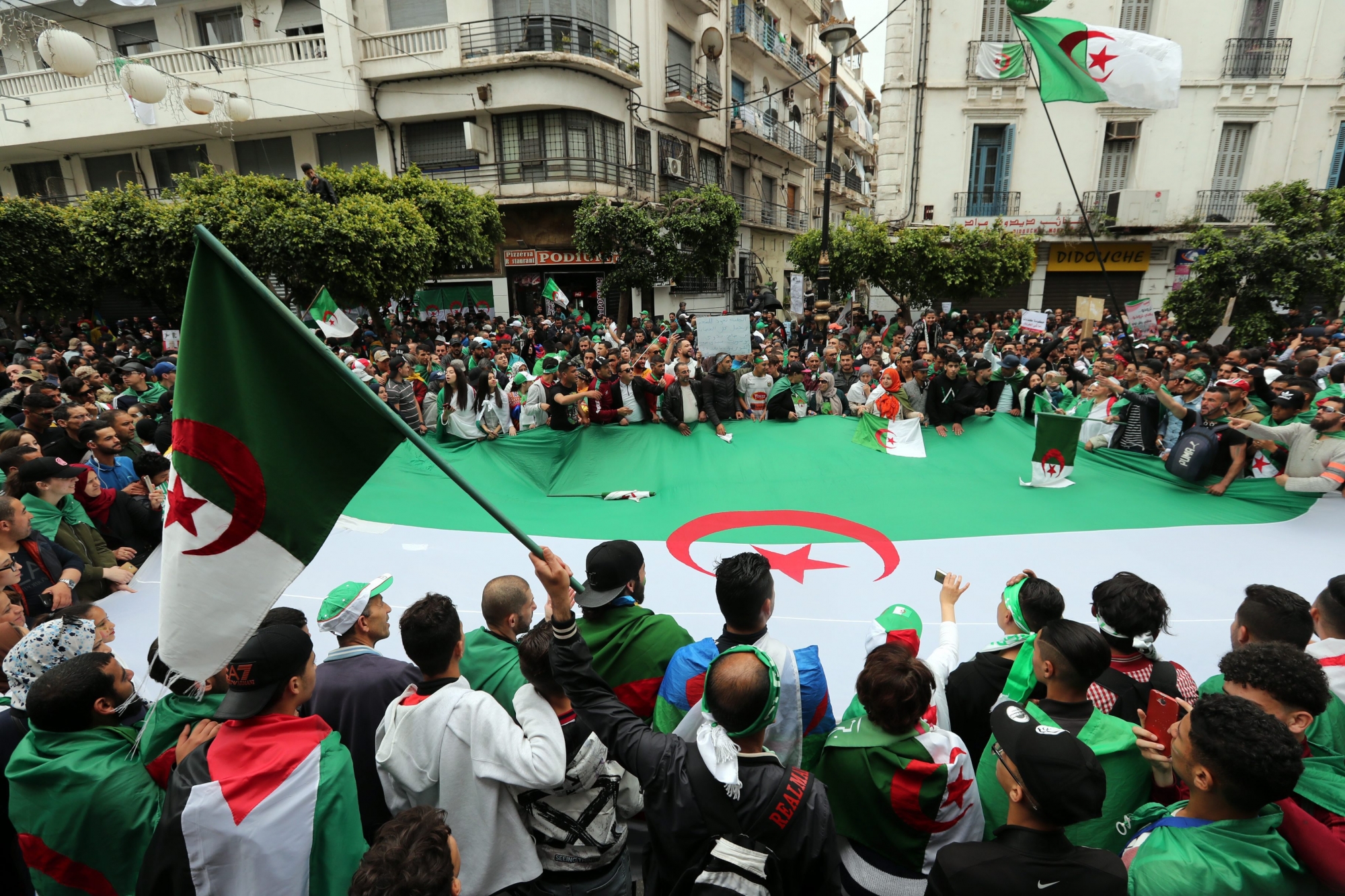 epa07516050 Algerians protest during a demonstration for the departure of the Algerian regime in Algiers, Algeria, 19 April 2019. The Algerian protests that began in early February 2019, after the former president announced his candidacy for a fifth presidential term, continue to call for radical change of the system.  EPA/MOHAMED MESSARA ALGERIA PROTEST