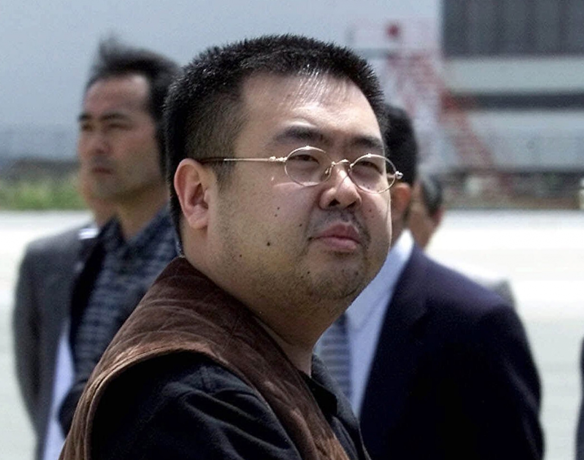 FILE - In this May 4, 2001, file photo, a man believed to be Kim Jong Nam, the eldest son of then North Korean leader Kim Jong Il, looks at a battery of photographers as he exits a police van to board a plane to Beijing at Narita international airport in Narita, northeast of Tokyo. Police in Malaysia say the half brother of North Korea's leader who was killed in a Kuala Lumpur airport more than a week ago had a nerve agent on his eye and his face. A statement Friday, Feb. 24, 2017 from the inspector general of police said that a preliminary analysis from the Chemistry Department of Malaysia identified the agent at "VX NERVE AGENT." (AP Photo/Shizuo Kambayashi, File) Malaysia North Korea