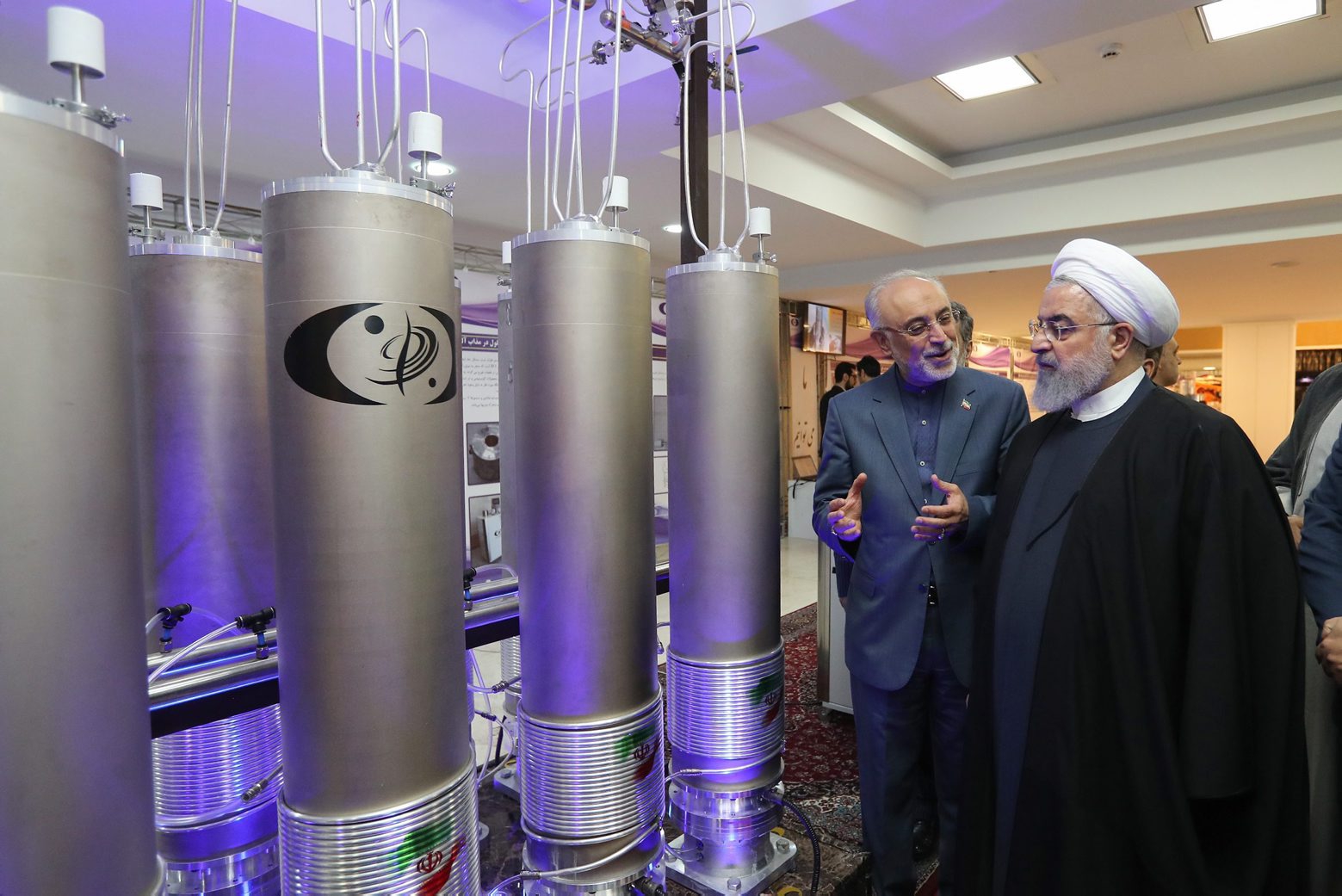 epa07700786 (FILE) - A handout file picture made available by the presidential office shows Iranian President Hassan Rouhani (R) and the head of Iran nuclear technology organization Ali Akbar Salehi inspecting nuclear technology on the occasion of Iran National Nuclear Technology Day in Tehran, Iran, 09 April 2019 (reissued 07 July 2019). Iran on 07 July 2019) said it was to exceed the limit on uranium enrichment, the second such breach that crosses the limit set in 2015 in a nuclear agreement with leading powers. Iranian government press spokesperson Ali Rabiei said at a press conference Iran would cross the limit of 3.67 per cent enrichment.  EPA/IRANIAN PRESIDENCY OFFICE HANDOUT  HANDOUT EDITORIAL USE ONLY/NO SALES (FILE) IRAN NUCLEAR DEAL ENRICHED URANIUM