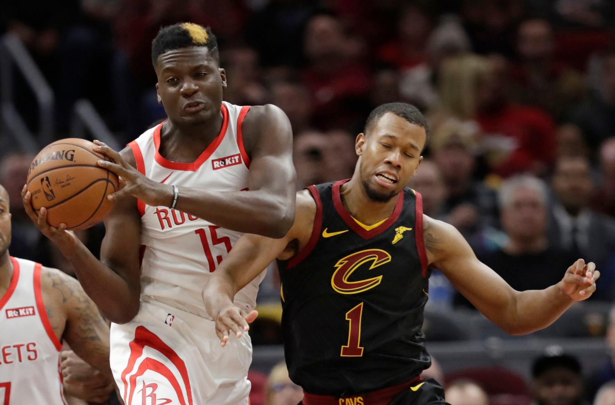 Houston Rockets' Clint Capela (15), from Switzerland, and Cleveland Cavaliers' Rodney Hood (1) battle for a rebound in the first half of an NBA basketball game, Saturday, Nov. 24, 2018, in Cleveland. (AP Photo/Tony Dejak) ROCKETS CAVALIERS BASKETBALL