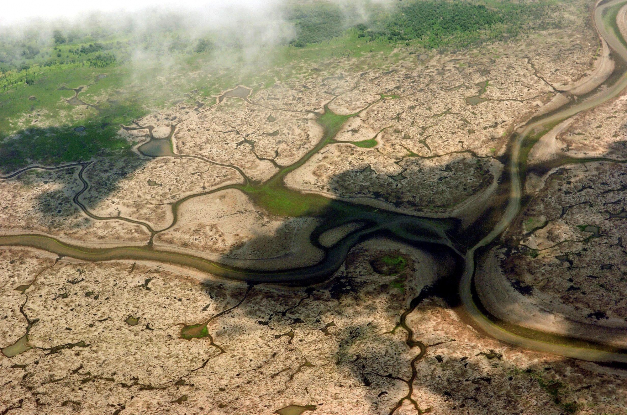FILE - In this Oct. 12, 2005 file photo is seen the Anama Lake after a drought affected the levels of parts of the Amazon River in Manaus, Brazil.   In 2005, the water level of the Amazon dropped by several feet because of a months long drought, halting travel and harming the important fishing industry. In 2009, communities along the river are adding new floors to their stilt houses, trying to stay above rising floodwaters that have killed 44 people and left 376,000 homeless.  (AP Photo/Luiz Vasconcelos, Interfoto, File) Brazil Climate Chaos