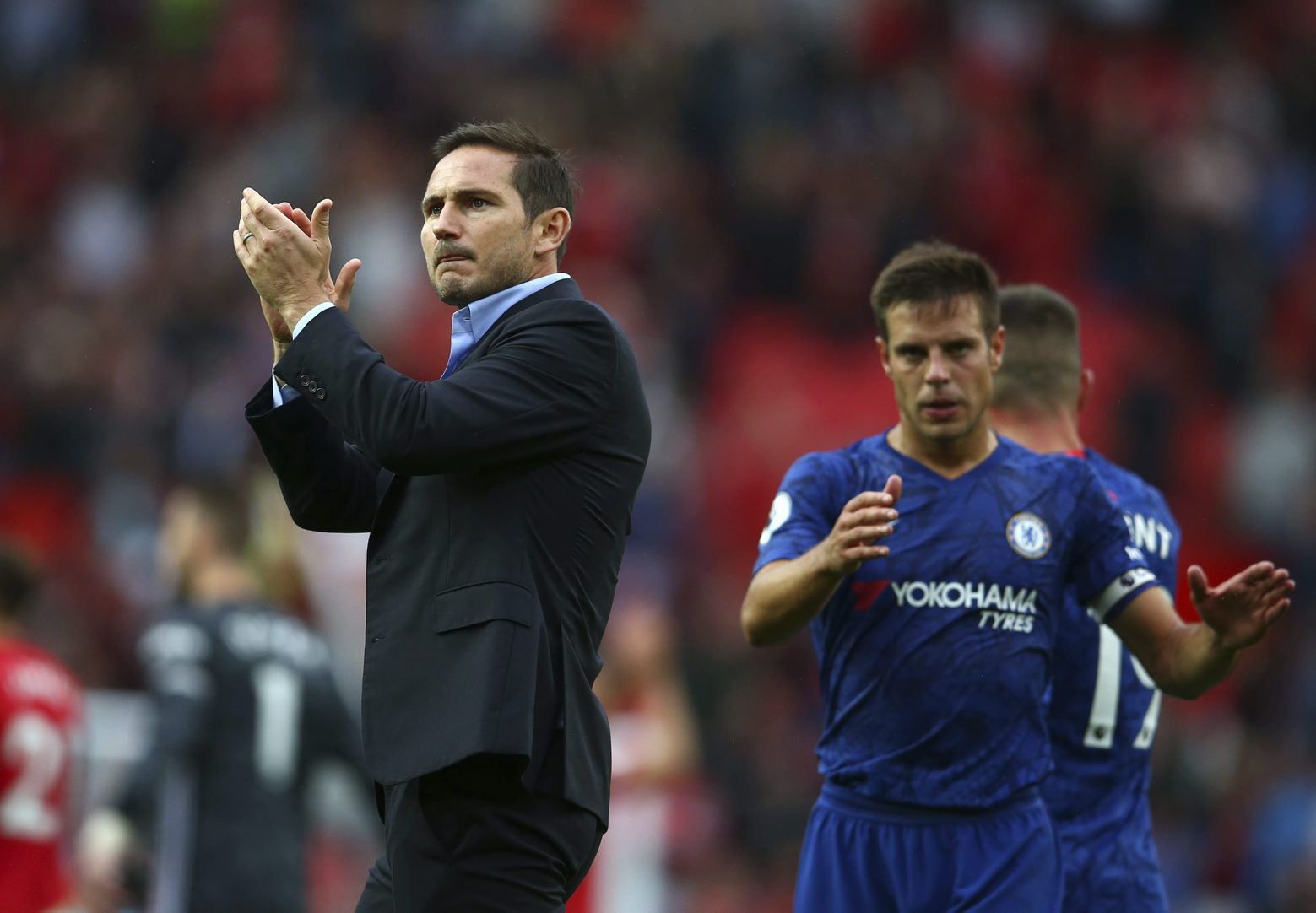 Chelsea's head coach Frank Lampard, left, and Chelsea's Cesar Azpilicueta acknowledge spectators after the English Premier League soccer match between Manchester United and Chelsea at Old Trafford in Manchester, England, Sunday, Aug. 11, 2019. (AP Photo/Dave Thompson) Britain Soccer Premier League