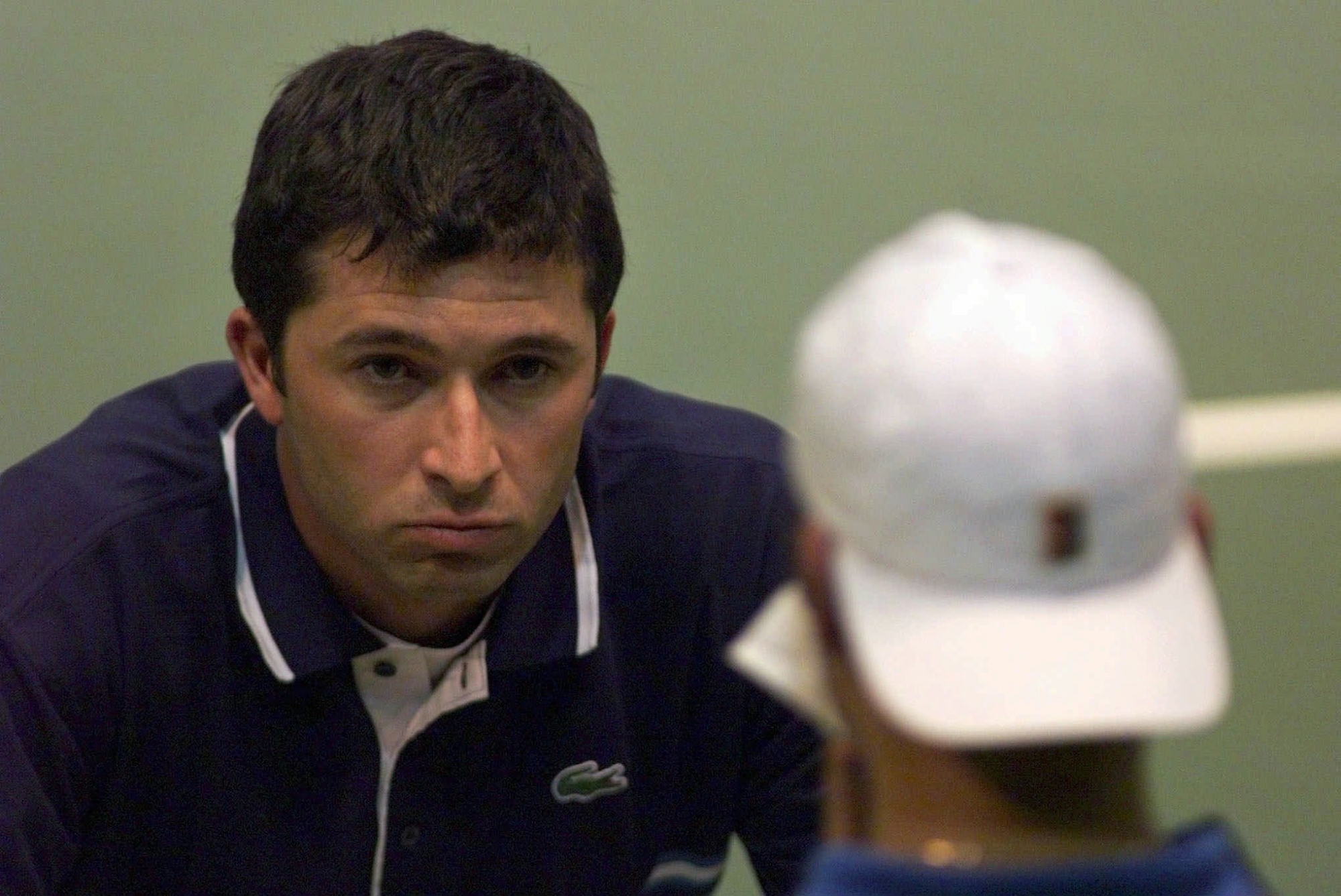 Swiss team captain Claudio Mezzadri, left, talks to his tennis player Roger Federer between games in Federer's match against Davide Sanguinetti of Italy in the Davis Cup round Switzerland vs Italy, Friday, April 2, 1999 in Neuchatel.  (ELECTRONIC IMAGE)  (KEYSTONE/Alessandro della Valle)