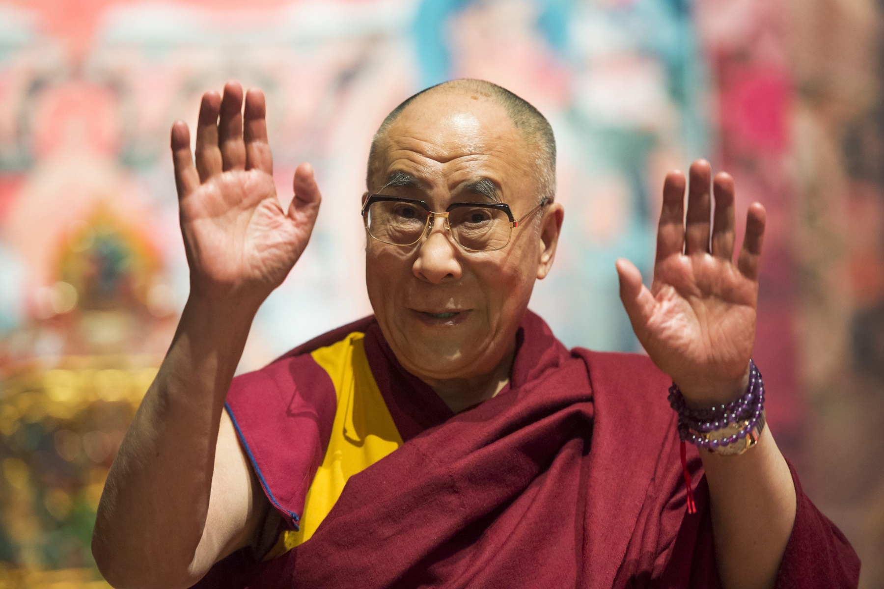 Tibetan spiritual leader Dalai Lama gestures during a spiritual event at the Forum Arena in Fribourg, western Switzerland, Sunday, April 14, 2013. The Dalai Lama pays a four day visit to Switzerland. (KEYSTONE/Jean-Christophe Bott)