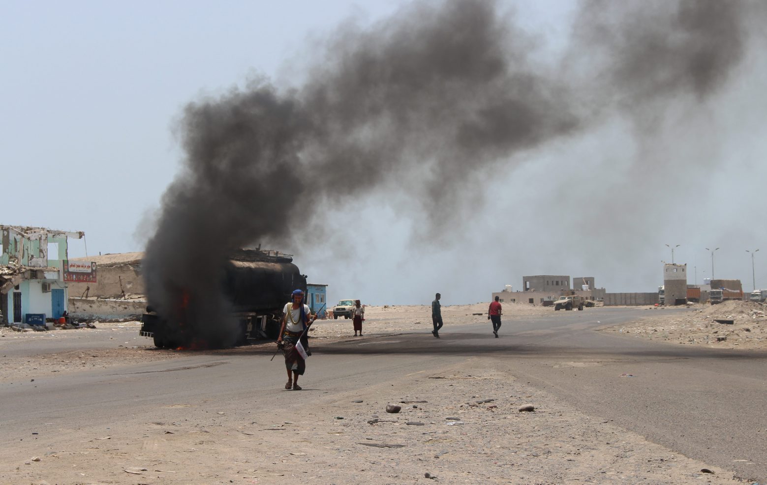 People inspect an oil tanker truck set ablaze during recent clashes between Yemeni southern separatists and government forces near Aden, Yemen, Friday, Aug. 30, 2019.Â (AP Photo/Wail al-Qubaty) APTOPIX Yemen