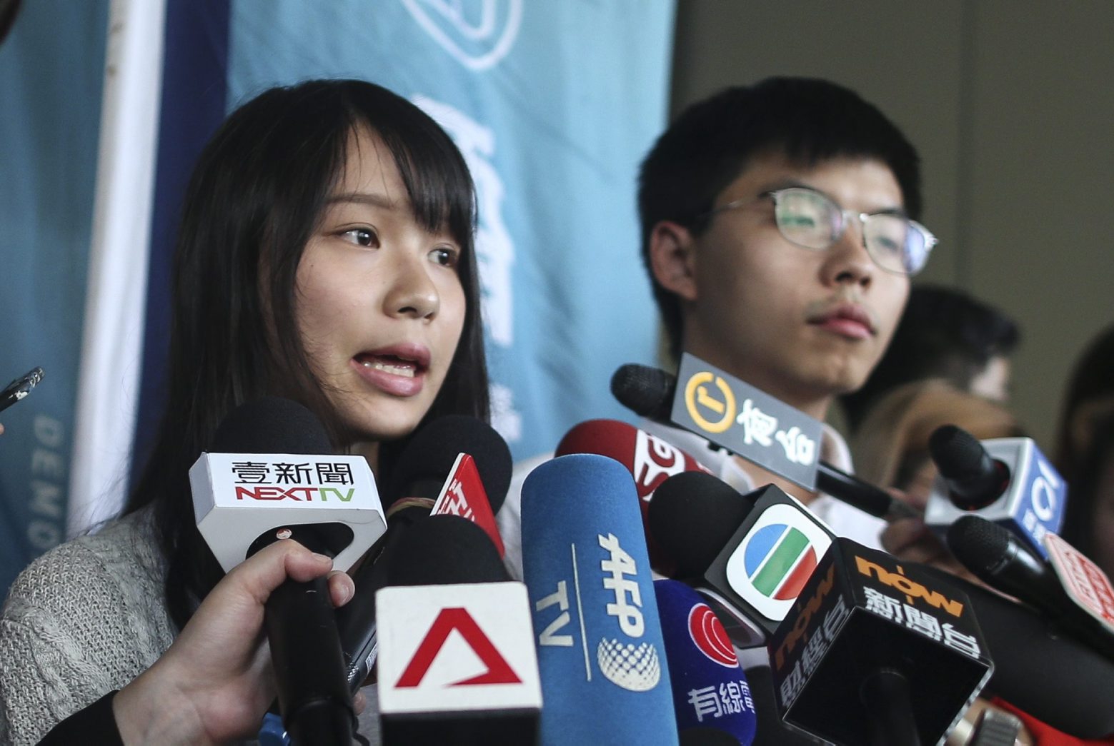 epa07803656 Leaders of Demosisto, a pro-democracy organization promoting self-determination for Hong Kong, Joshua Wong (R) and Agnes Chow (L) speak to the press after they were released on bail in Wan Chai police headquarters, Hong Kong, China, 30 August 2019. According to reports on 30 August 2019, political activist and Demosisto leader Joshua Wong and fellow Demosisto member Agnes Chow were arrested for their involvement in an unlawful assembly during the besiege of the Wan Chai police headquarters on June 21. For over two months, Hong Kong has been gripped by mass protests, which began in June over a now-suspended extradition bill to China and have developed into an anti-government movement.  EPA/JEROME FAVRE CHINA HONG KONG PROTESTS