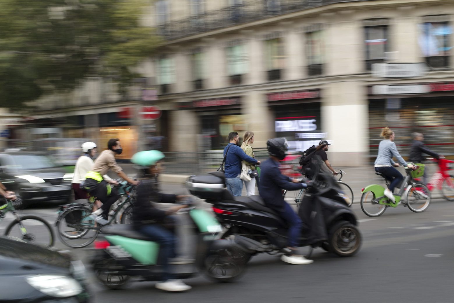 People ride bicycles and scooters in a street of Paris, Friday, Sept. 13, 2019. Paris metro warns over major strike, transport chaos Friday. (AP Photo/Thibault Camus) France Strike