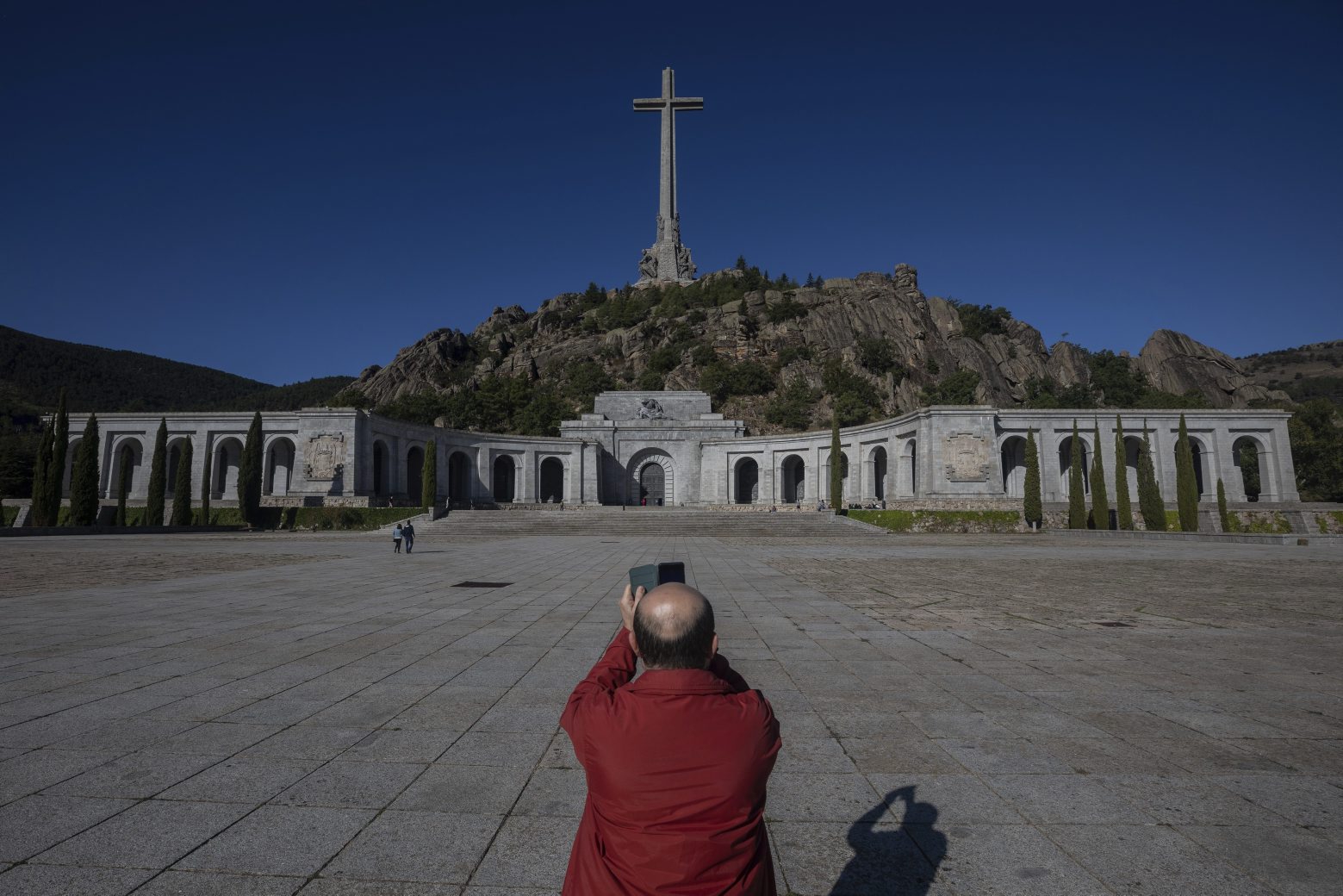 A visitor takes a snapshot at the Valley of the Fallen mausoleum near El Escorial, outskirts of Madrid, Spain, Tuesday, Sept. 24, 2019. The Spanish Supreme Court has ruled that the caretaker Socialist government can exhume the remains of former dictator Gen. Francisco Franco. Leftist parties and families of many Spanish Civil War victims have long wanted Franco to be removed from the mausoleum, which is a major tourist attraction. Others argue this would open old wounds. (AP Photo/Bernat Armangue) APTOPIX Spain Franco's Remains