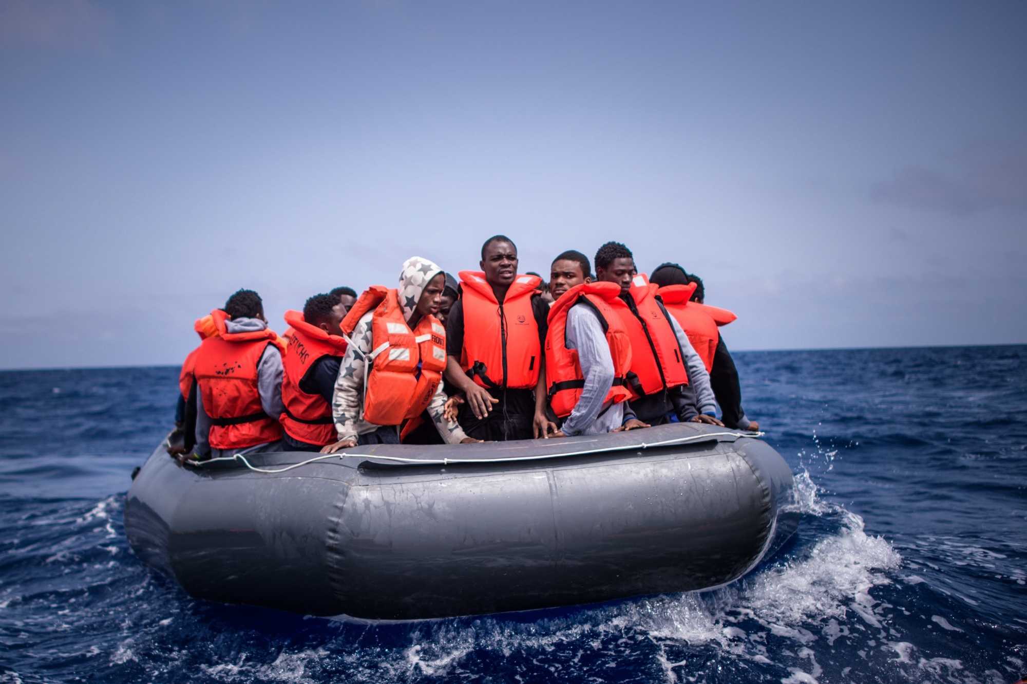 epa06677195 Refugees on a rubber dinghy are rescued by members of the NGO 'SOS Mediterranee' from the 'Aquarius' vessel during an operation to rescue migrants, about 50 kilometers off the Libyan coast, in the Mediterranean Sea, 18 April 2018. Approximatly 100 people, mostly from western Africa, were rescue by the Aquarius crew after leaving the Libyan coast 10 hours before.  EPA/CHRISTOPHE PETIT TESSON AT SEA MIGRATION RESCUE
