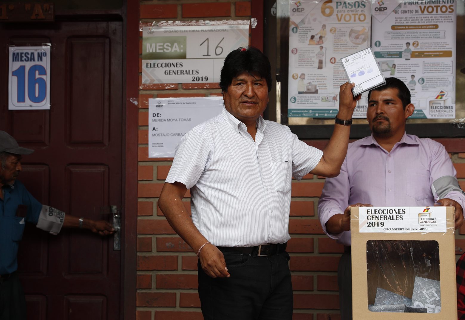 Bolivia's President Evo Morales, left, poses for a picture before casting his vote in Villa 14 de Septiembre, in the Chapare region, Bolivia, Sunday, Oct. 20, 2019. Bolivians are voting in general elections Sunday where Morales is Presidential candidate for a fourth term.(AP Photo/Juan Karita) Bolivia Elections