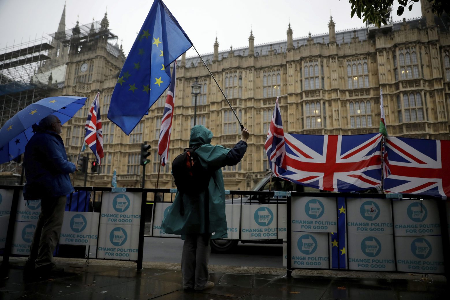 Anti-Brexit remain in the European Union supporters protest backdropped by the Houses of Parliament in London, Thursday, Oct. 24, 2019. Britain's Prime Minister Boris Johnson won Parliament's backing for his exit deal on Wednesday, but then lost a key vote on its timing, effectively guaranteeing that Brexit won't happen on the scheduled date of Oct. 31.  (AP Photo/Matt Dunham) Britain Brexit