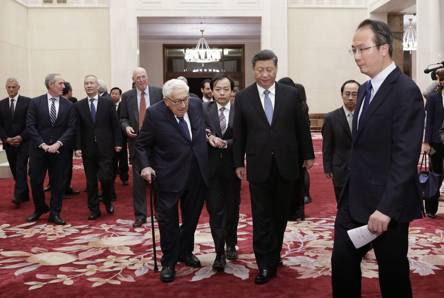 Chinese President Xi Jinping, center right, and former U.S. Secretary of State Henry Kissinger, center left, walk for a meeting with delegates from the 2019 New Economy Forum at the Great Hall of the People in Beijing Friday, Nov. 22, 2019. (Jason Lee/Pool Photo via AP) China US Kissinger