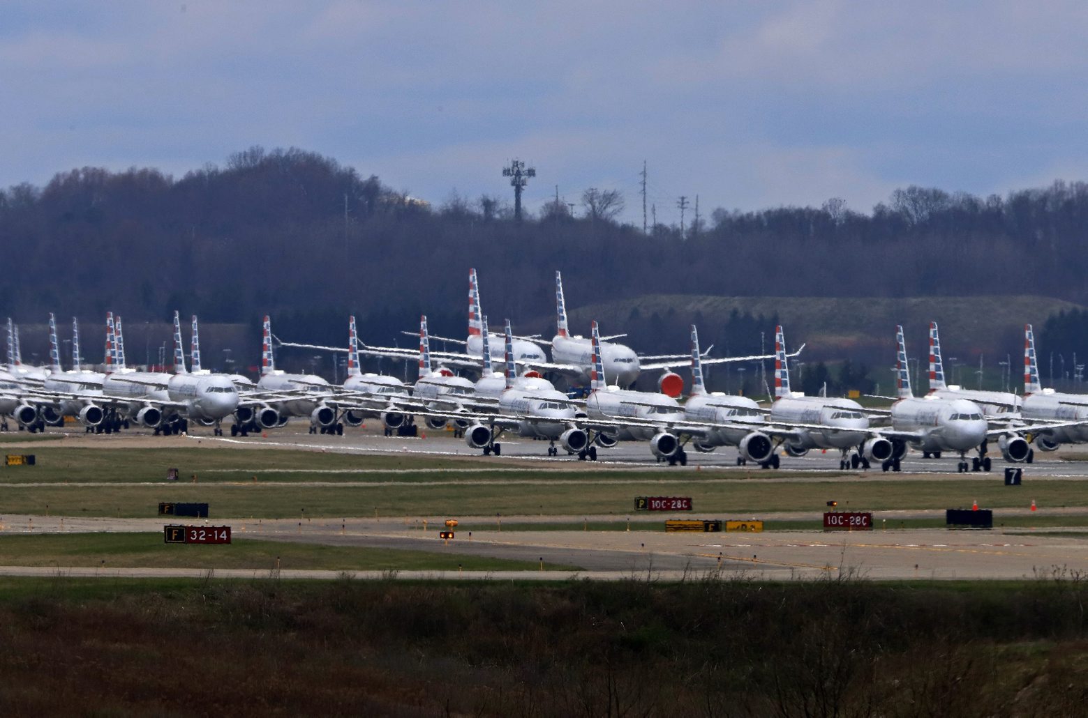 American Airlines planes stored at Pittsburgh International Airport sit idle on a closed runway in Imperial, Pa., on Tuesday, March 31, 2020. As airlines cut more service, due to the COVID-19 pandemic, Pittsburgh International Airport has closed one of its four runways to shelter in place 96 planes, mostly from American Airlines, as of Monday, March 30, 2020. The airport has the capacity to store 140 planes.(AP Photo/Gene J. Puskar) Virus Outbreak Pennsylvania Travel