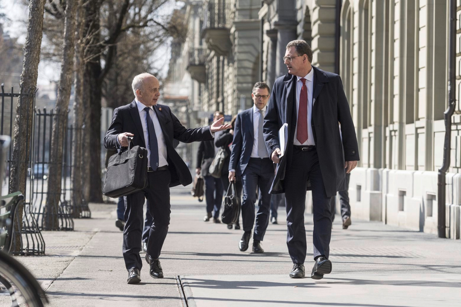 Swiss Federal councillor and finance minister Ueli Maurer, left, and Thomas Jordan, chairman of the governing board of the Swiss National Bank, walk to a media brief about the latest economic measures during the Covid-19 Coronavirus pandemic, on Wednesday, March 25, 2020 in Bern, Switzerland. (KEYSTONE/Alessandro della Valle) SWITZERLAND GOVERNMENT CORONAVIRUS